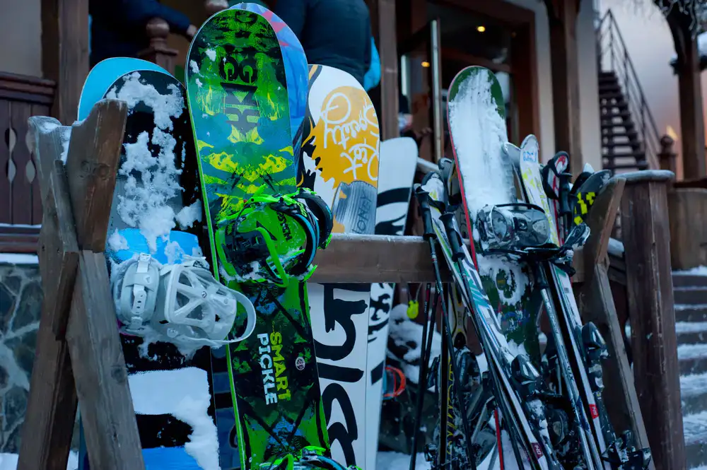 Rows of pristine rental skis and snowboards arranged in the shop